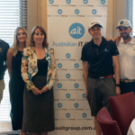 6 people standing in front of a banner that reads Aus IT Group