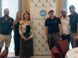 6 people standing in front of a banner that reads Aus IT Group