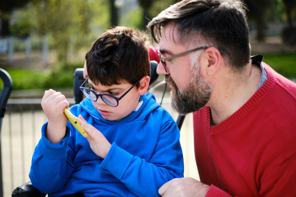 Child with disability uses a smart phone to help communicate to his parent/carer